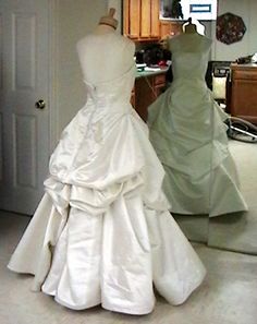 a wedding dress on display in a shop window