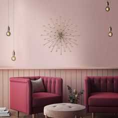 a living room with two chairs and a coffee table in front of a pink wall