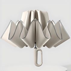 an umbrella with five white bags hanging from it's side and one in the middle