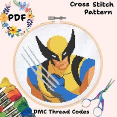 a cross stitch pattern with scissors and thread on the table next to it is an image of wolverine