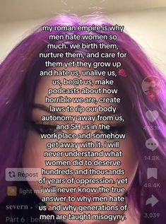 a woman with long purple hair is looking at the camera and has words written on her face