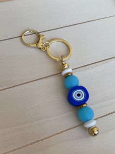 Add a pop of color to your keys with our silicone beaded keychain. Whether it's for yourself or a thoughtful gift for a new driver, this keychain is a perfect accessory!    Crafted with non-toxic, food, grade, silicone beads, this keychain is not only fashionable, but also safe for every day use. It's completely free of BPA, lead, phthalates, and cadmium.  The silicone keychain measures 5.75 inches from the top of the lobster clasp to the bottom of of the metal bead. Hardware color is gold. Evil Eye Keychain, Keychain Blue, Gifts For New Drivers, Silicone Keychain, Key Ring Holder, Car Key Chain, Beaded Keychain, New Driver, Metal Bead