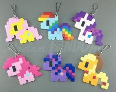 the pixel keychains have been made out of different types of plastic beads and are colorful