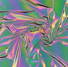 an abstract image of purple and green fabric with metallic foil on the bottom, as well as