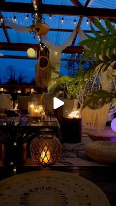 a room filled with lots of plants and lights on the ceiling next to a window