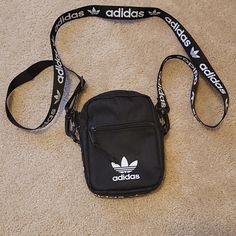 Cleaning The Closet Of Things That Don't Get Much Use Or None At All. This Brand New Bag Is Approximately 5"7" In Size. Nice Adidas Logos Around The Edge Of Bag And Along The Strap. Thanks For Looking. Black Mobile Phone Shoulder Bag For Streetwear, Adidas Rectangular Shoulder Bag For Daily Use, Adidas Rectangular Bag For Daily Use, Trendy Adidas Shoulder Bag With Adjustable Strap, Adidas Everyday Shoulder Bag, Rectangular Adidas Bag For Everyday Use, Adidas Rectangular Bag For Everyday Use, Adidas Shoulder Bag With Removable Pouch For Daily Use, Adidas Crossbody Bag For Everyday Use