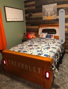 a bed made up to look like an old school car with the word chevrolet written on it