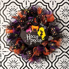 a halloween wreath with the words hocus pocuss on it