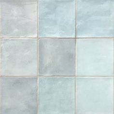 a white and blue tiled wall with no grout