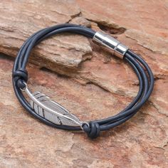 Circling the wrist with cord of navy leather this bracelet culminates in a stunning feather pendant crafted from stainless steel. Thai artisan Passaramon designs this bracelet which closes with a magnetic clasp. Western Fashion Jewelry, Basic Bracelet, Faux Leather Bracelets, Leather Pendant, Hand Painted Jewelry, Feather Pendant, Navy Leather, Photo Bracelet, Black Stainless Steel