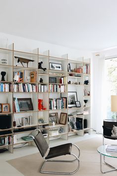 a living room filled with furniture and bookshelves