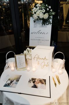 a white table topped with pictures and candles