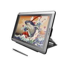 a tablet with a pen sitting on top of it next to an image of a fish