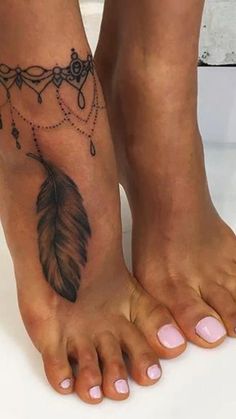 a woman's foot with a feather and beads tattoo on the bottom of it