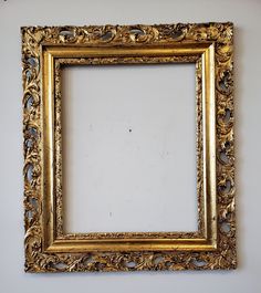 an ornate gold frame hanging on the wall