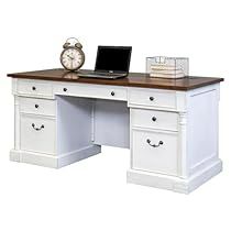 an office desk with two drawers and a laptop on the top, in front of a clock