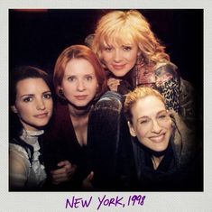 four women are posing for a photo together