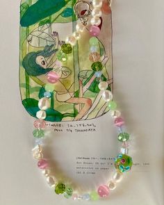 Immerse yourself in the enchanting colors of a spring meadow with our "Life On Venus" beaded necklace. Handcrafted with meticulous attention to detail, this necklace features a vibrant array of green, pink, and blue beads. Adorned with a charming flower glass charm, this necklace captures the essence of a blooming garden, adding a touch of whimsy and natural beauty to any outfit. Fairy Necklaces, Y2k Phone, Handmade Beaded Necklace, Bead Charms Diy, Beaded Necklace Diy, Phone Charms, Handmade Beaded Necklaces, Garden Jewelry