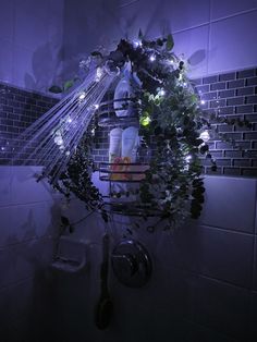 a shower head with plants and lights on it