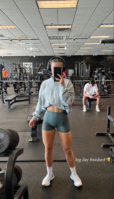 a woman taking a selfie in the gym