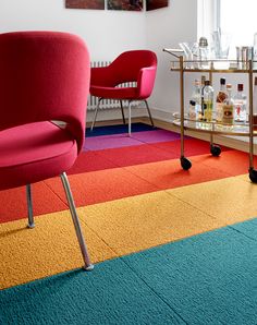 a room with colorful carpet and chairs in it