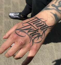 a man with a tattoo on his hand that says, happy new year written in cursive writing