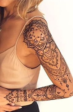 a woman with tattoos on her arms and arm