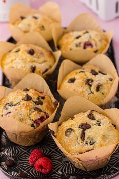 muffins with chocolate chips and raspberries on a plate