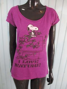 Vintage 'Peanuts' tee-shirt size 12 UK. Purple cap sleeve, snoopy on his house and 'I love nature' written underneath. Dimensions: Bust: 35 Inches. Length: 23 Inches. Made by PEANUTS Peanuts Shirts Vintage, Size 12 Uk, Peanuts Snoopy, Cap Sleeve, Cap Sleeves, Tee Shirt, Peanut, Snoopy, Size 12