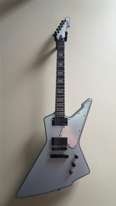 an electric guitar hanging on the wall