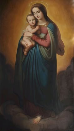 the virgin mary holding a child in her arms