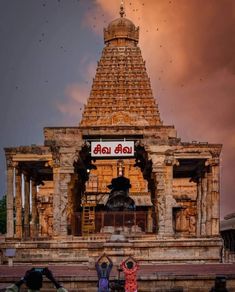 two people are standing in front of a temple