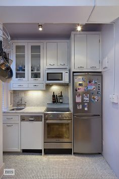 a kitchen with stainless steel appliances and white cabinets