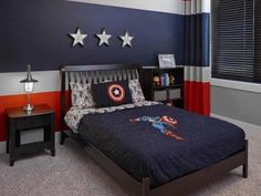 a bedroom decorated in red, white and blue with captain america themed decor on the wall