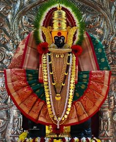 an idol is displayed in front of a wall