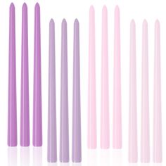 six pastel colored candles lined up in rows, all with different shapes and sizes