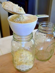 two jars filled with food sitting on top of a wooden table