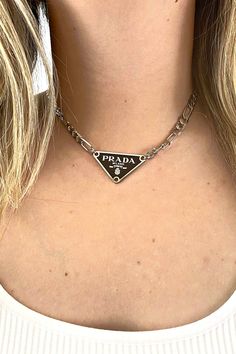 Prada Designer Triangle Necklace – Embellish Your Life Elegant Metal Necklace With Silver-tone Logo, Silver Necklace With Silver-tone Logo Plaque, Luxury Silver Chain Necklace With Logo Charm, Designer Silver Jewelry With Clavicle Chain, Silver Cuban Chain, Prada Aesthetic, Prada Triangle, Prada Jewelry, Extension Lead