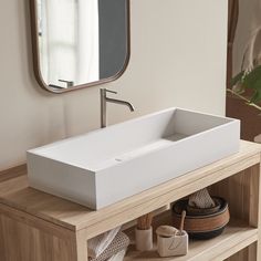 a bathroom sink sitting on top of a wooden counter