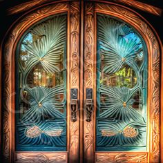 an ornate wooden door with glass panels