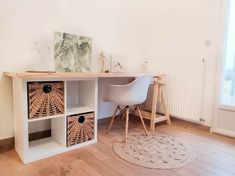 a white desk with two baskets on it