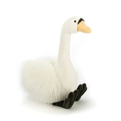 a white duck sitting on top of a white floor next to a black and white object