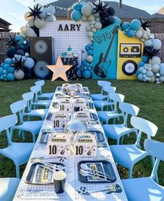 a table set up for an army themed birthday party with balloons and decorations on the wall