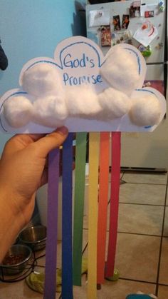 a person holding up a cloud with the word god's promise written on it