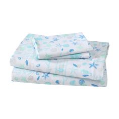 three sheets with blue and white sea animals on them, one is folded up to show the