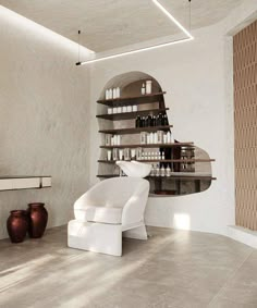 a white chair sitting on top of a floor next to a shelf filled with bottles