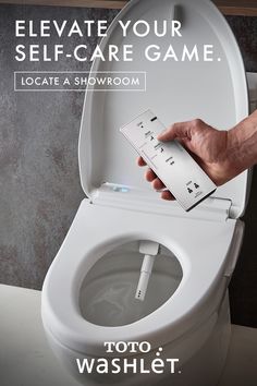 a toilet with the lid up and someone holding a card in their hand to flush it