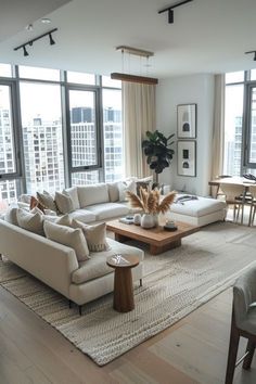 a living room filled with furniture and large windows