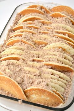 a casserole dish filled with bread and crumbs on top of it