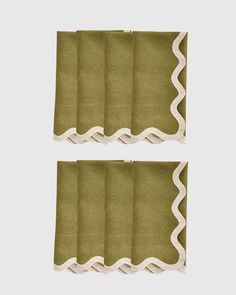 two pieces of green fabric with scalloped edges